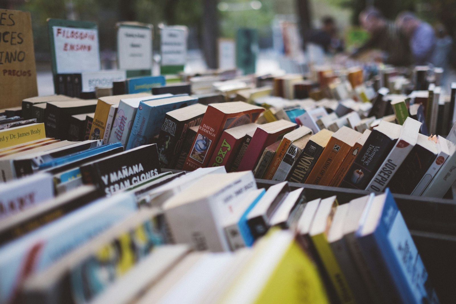 Crates of used books at an outdoor stall, titles facing out. It accompanies an article about Naming a product without boxing the company in.