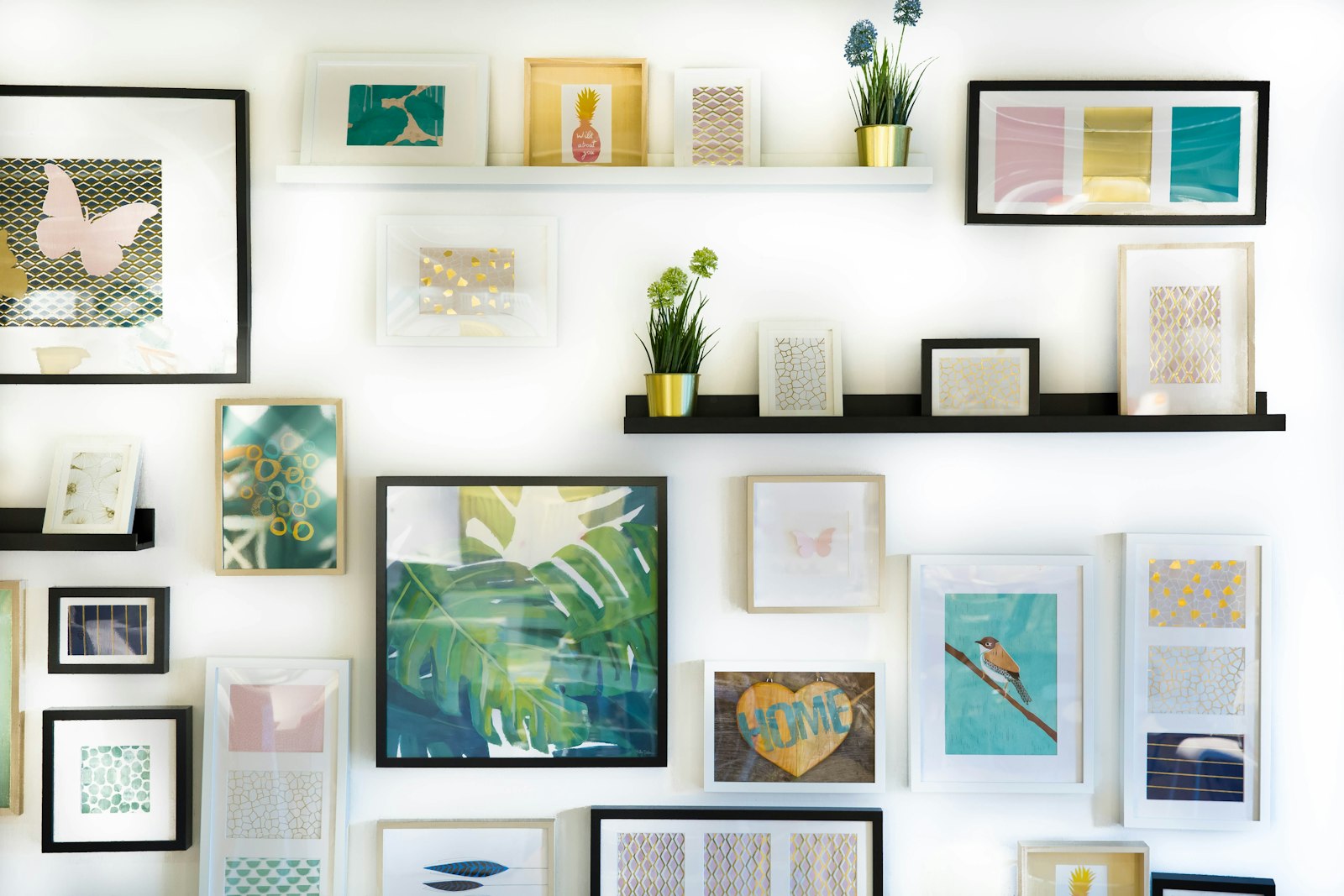 A white wall covered with framed prints, small plants, and two floating shelves. It accompanies an article about Ecommerce design for a brand, not a marketplace.
